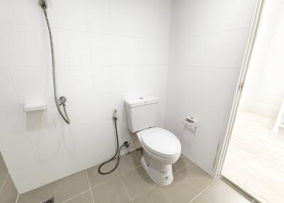 Modern bathroom with white tiles and a toilet