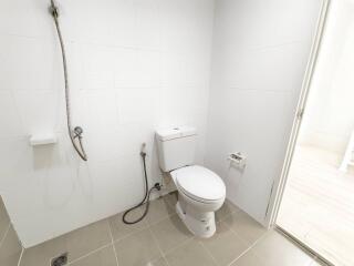 Modern bathroom with white tiles and a toilet