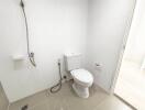 Modern bathroom with white tiles and a toilet