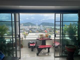 Balcony with a scenic view of the city and mountains