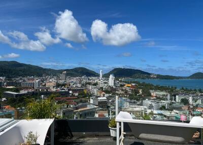 Panoramic view from rooftop of a city and nearby coastline