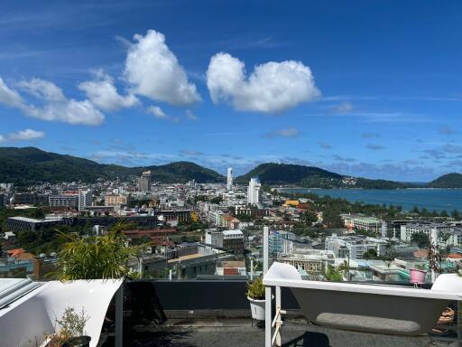 Panoramic view from rooftop of a city and nearby coastline