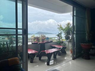 Balcony with outdoor seating and view of the sea