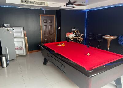 Room with a pool table and a mini refrigerator