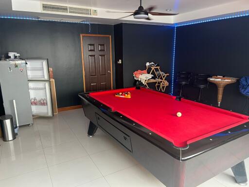 Room with a pool table and a mini refrigerator