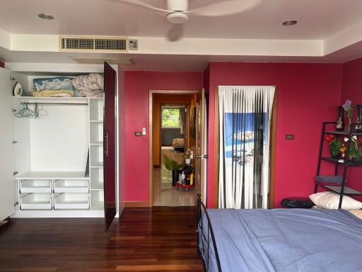 Bedroom with closet, ceiling fan, and bright red walls