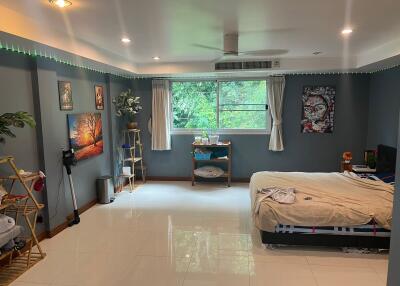 Spacious bedroom with wall art and large window