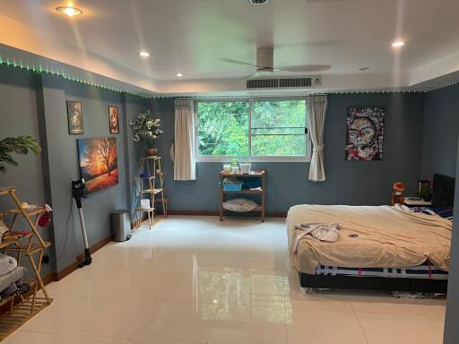 Spacious bedroom with wall art and large window