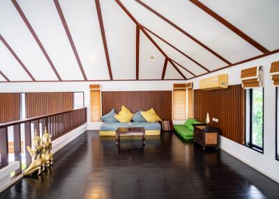 Spacious living room with wooden ceiling beams and modern furnishings