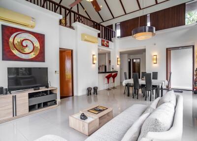 Spacious living room with modern decor and high ceiling