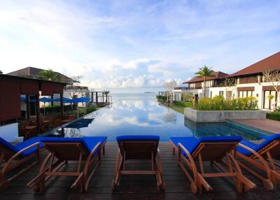 Outdoor seating area with pool and sea view