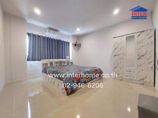 Spacious bedroom with modern decor and ample natural light