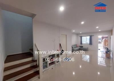 Spacious living room with stairs and a seating area