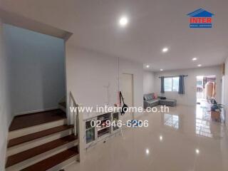 Spacious living room with stairs and a seating area