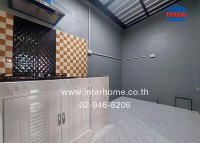 Modern kitchen with checkered backsplash and white cabinets