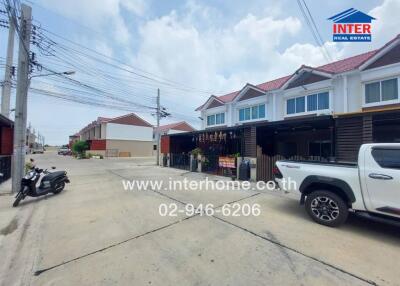 Street view of residential area with garages and vehicles