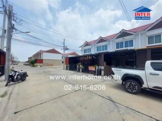 Street view of residential area with garages and vehicles