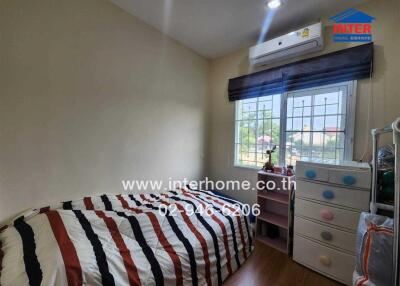 Small bedroom with single bed, air conditioner, window, and drawers