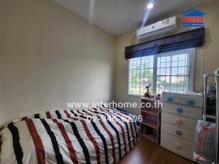 Small bedroom with single bed, air conditioner, window, and drawers