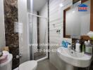 Modern bathroom with shower, sink, mirror, and tiled walls