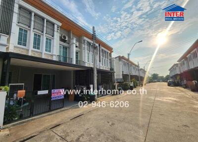 Two-storey residential houses along a sunny street