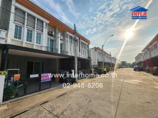 Two-storey residential houses along a sunny street