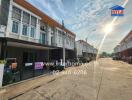 Two-storey residential houses along a sunny street