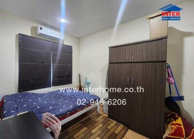 Small bedroom with a bed, air conditioner, wardrobe, and a window