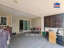 Covered patio with sliding doors leading to the interior, featuring various items