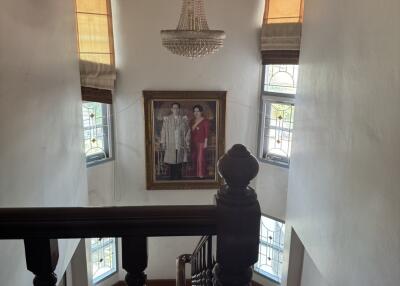 Stairwell with chandelier and framed artwork