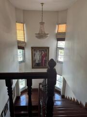 Stairwell with chandelier and framed artwork