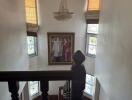 Stairwell with chandelier and framed artwork