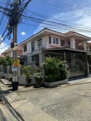 Two-story residential house with garden and driveway