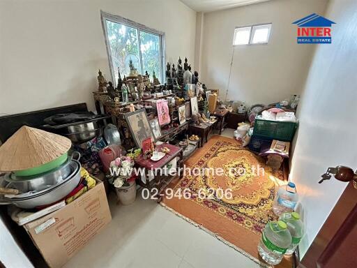 Small bedroom with personal items and traditional decorations