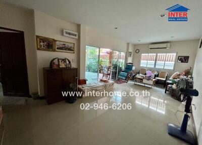 Spacious living room with modern furniture and sliding glass doors to the patio