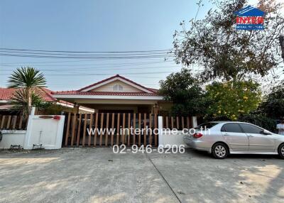 Front view of a house with driveway, garage, and car