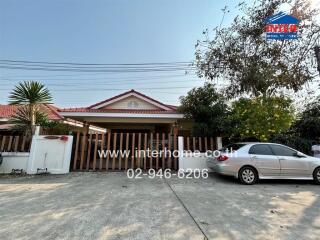 Front view of a house with driveway, garage, and car