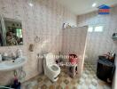 Bathroom with tiled walls and essential fixtures