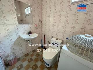 Bathroom with sink, toilet, and washing machine