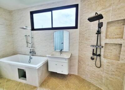 Modern bathroom with bathtub, shower, and sink