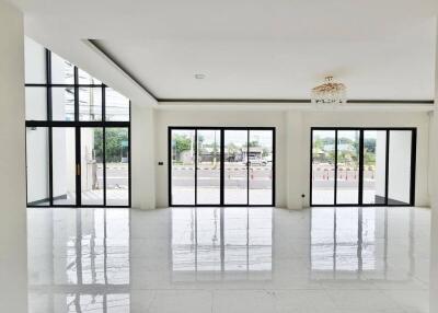 Spacious living room with large windows and modern flooring