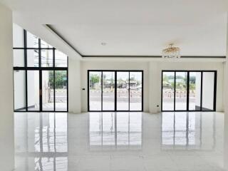 Spacious living room with large windows and modern flooring