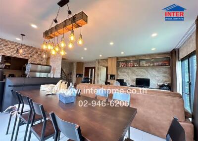 Spacious modern living area with dining table and open kitchen