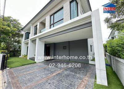 Exterior view of a two-story modern house with a driveway and garage