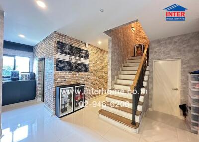 Modern living area with staircase and brick walls