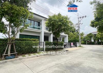 Real estate property exterior view with greenery and driveway