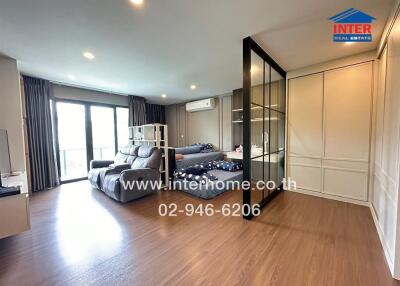 Spacious bedroom with modern furniture and large windows