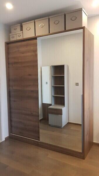 Bedroom with wooden wardrobe and mirror