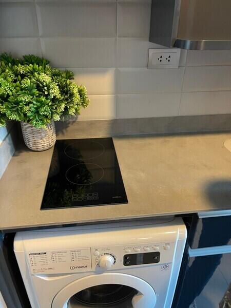 Modern kitchen with induction cooktop and washing machine