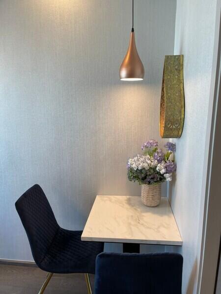 Small dining area with two chairs and a pendant light